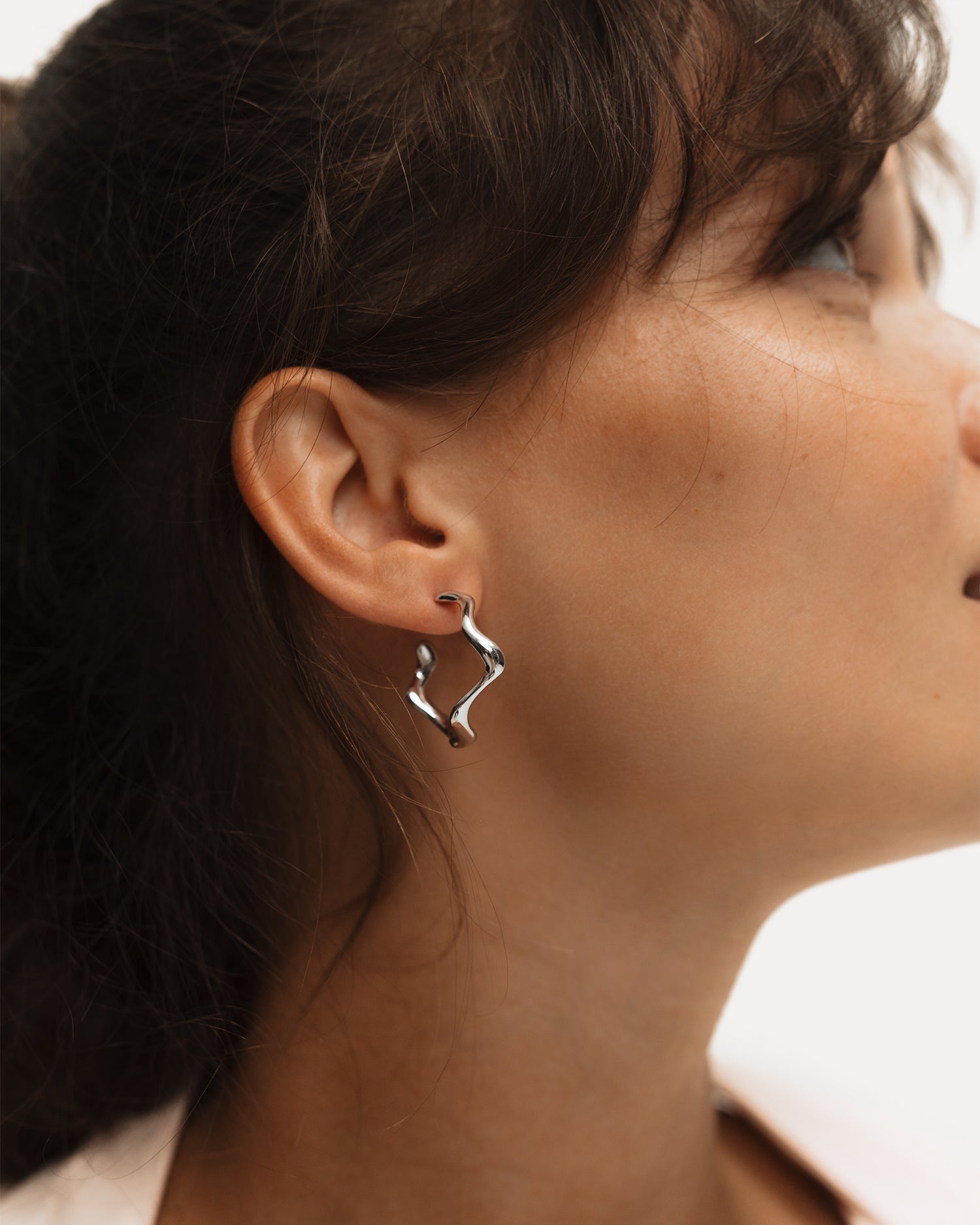 Poise Wave Hoop Earrings Large, recycled Sterling Silver, shown on ear - NATALIE GRASSI